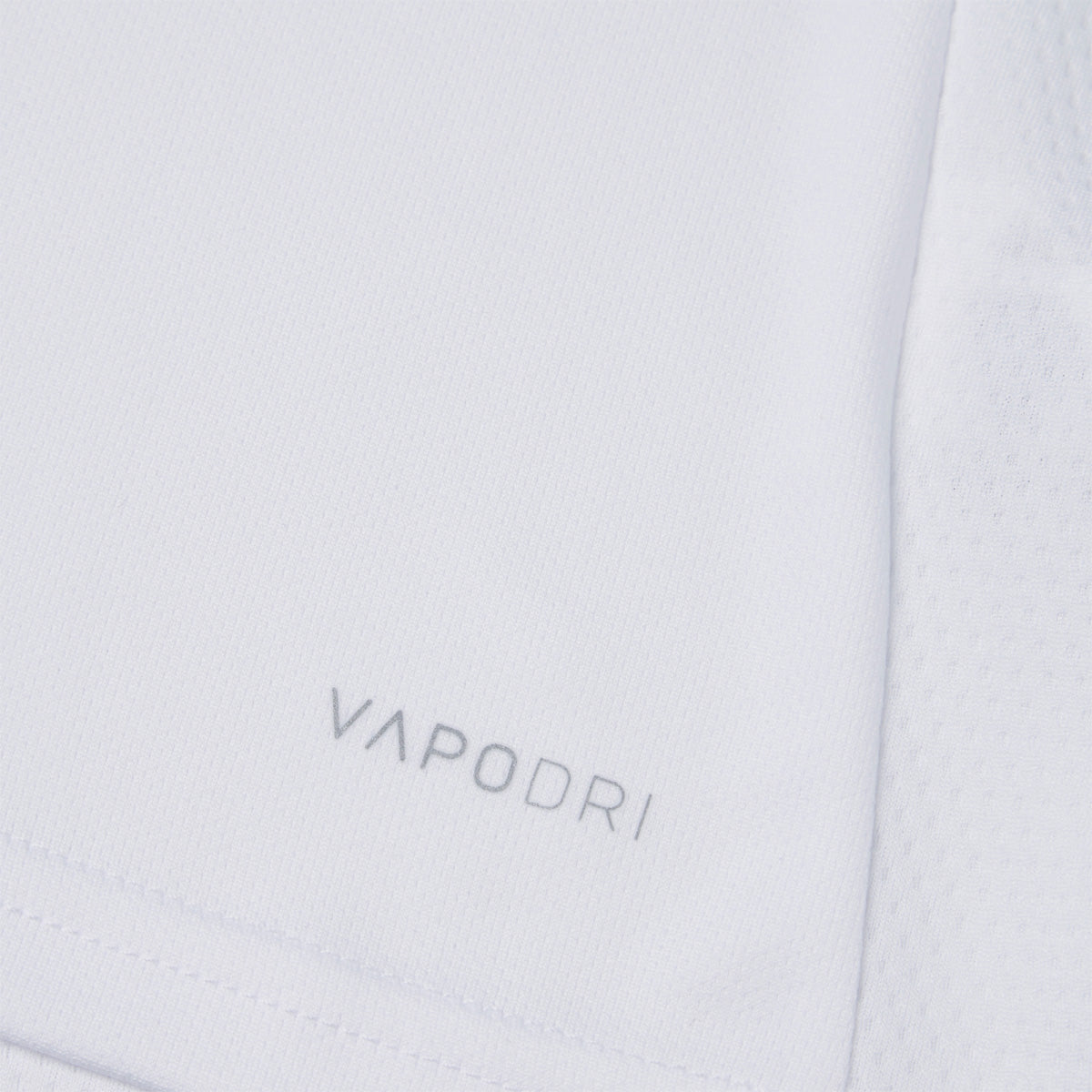 Photo of the Canterbury Club Dry Tee Junior in White, close up detail of VAPODRI logo
