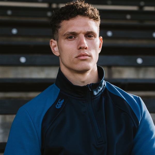 Photo of model wearing Canterbury Elite 1/4 Zip Top in Navy, shoulder & chest