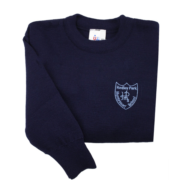 A photo of the Hedley Park Montessori School Pullover in Navy, with embroidered school crest and showing sleeeve detail