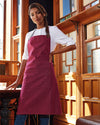 Staff member wearing 'Annex' Oxford Bib Apron