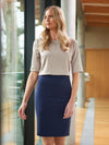 Model wearing Brook Taverner Numana Straight Skirt in Mid Blue