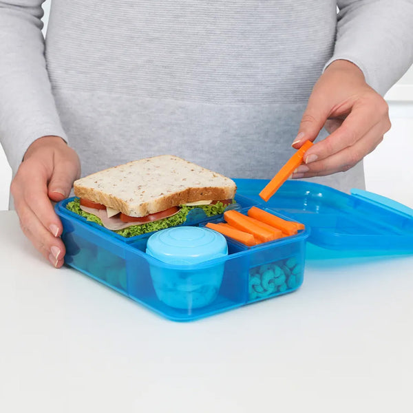 A lifeshot photo of the A photo of the Sistema Bento Lunch to Go w/ Yoghurt Pot 1.65 in colour blue, with lunch packing suggestion.