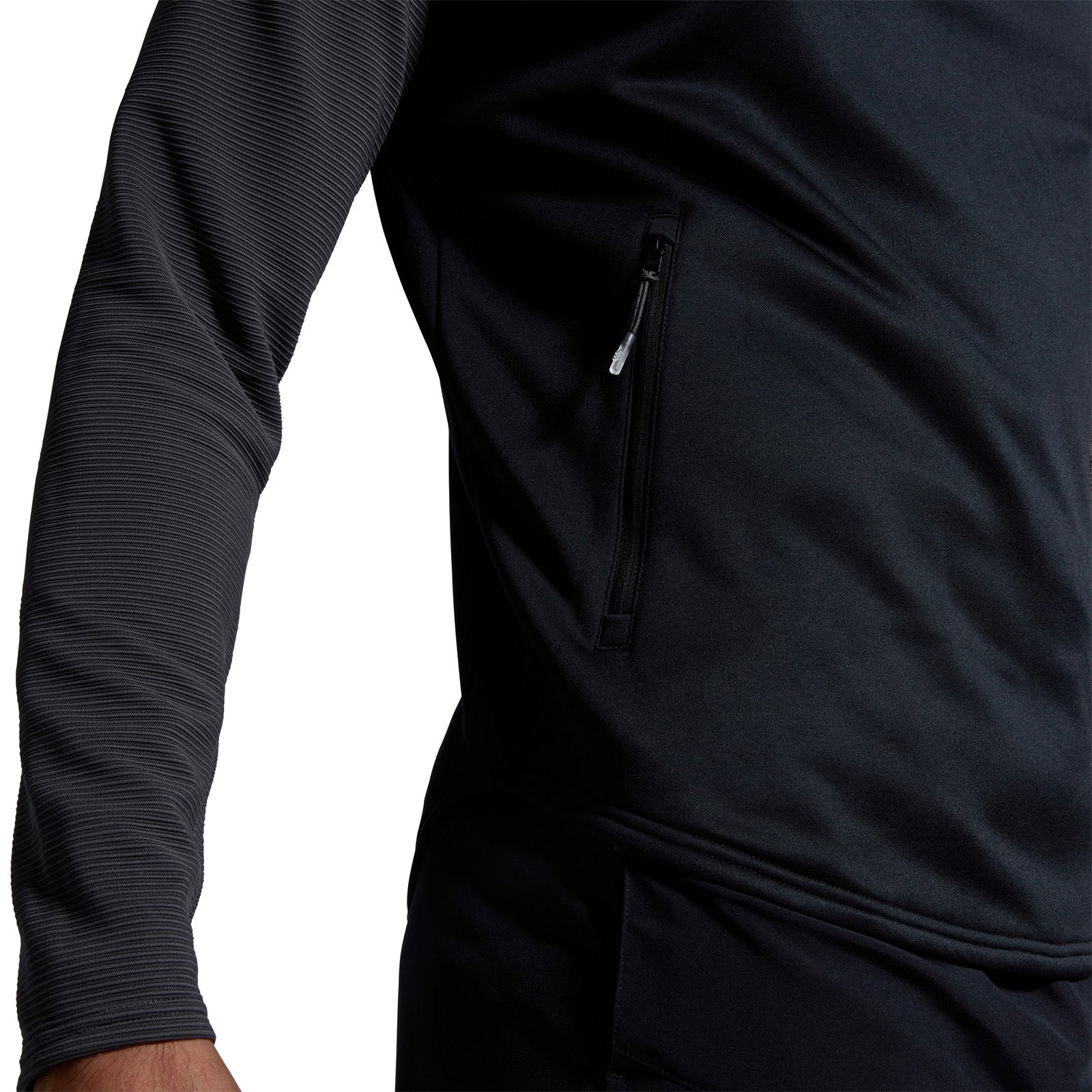 Photo of model wearing Canterbury Elite 1/4 Zip Top in Black, close up of hip & pocket detail