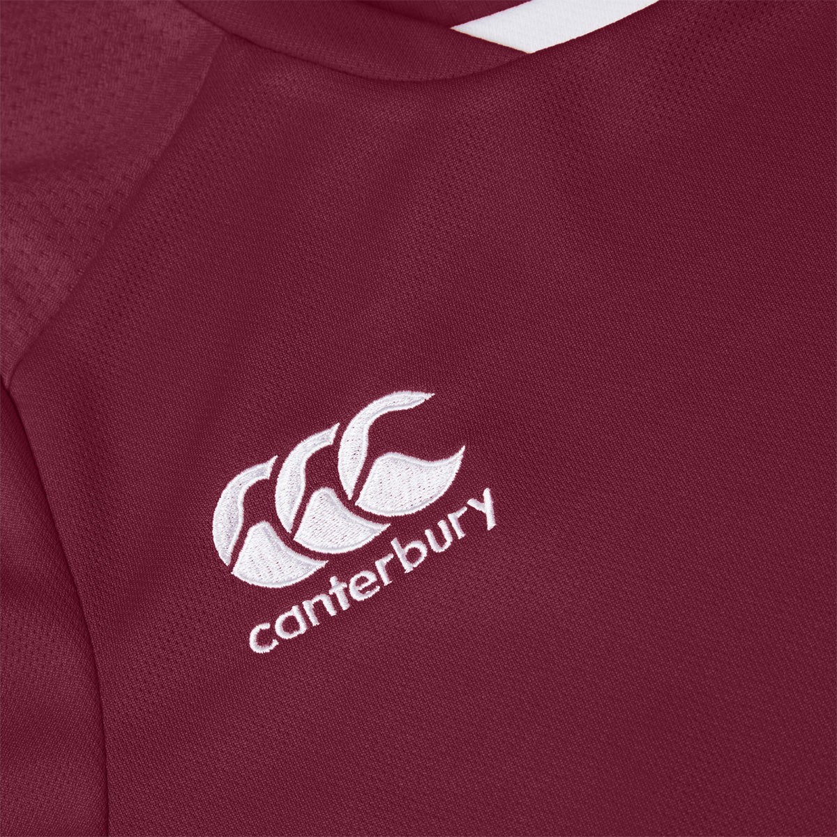 Photo of the Canterbury Club Dry Tee Junior in Maroon, close up image of the Canterbury logo detail