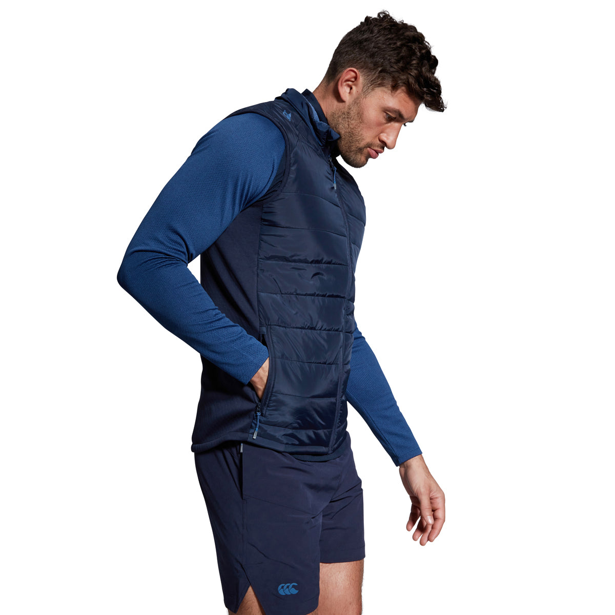 A photo of a model wearing the Canterbury Elite Microlight Gilet Navy, side view