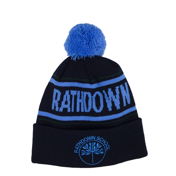 A photo of the Rathdown School Bobble Hat on Navy with 'Rathdown' in blue knitted in the hat. Embroidered school crest, front center.