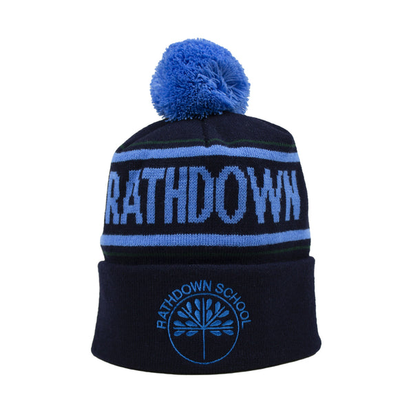 A photo of the Rathdown School Bobble Hat on Navy with 'Rathdown' in blue knitted in the hat. Embroidered school crest, front center.