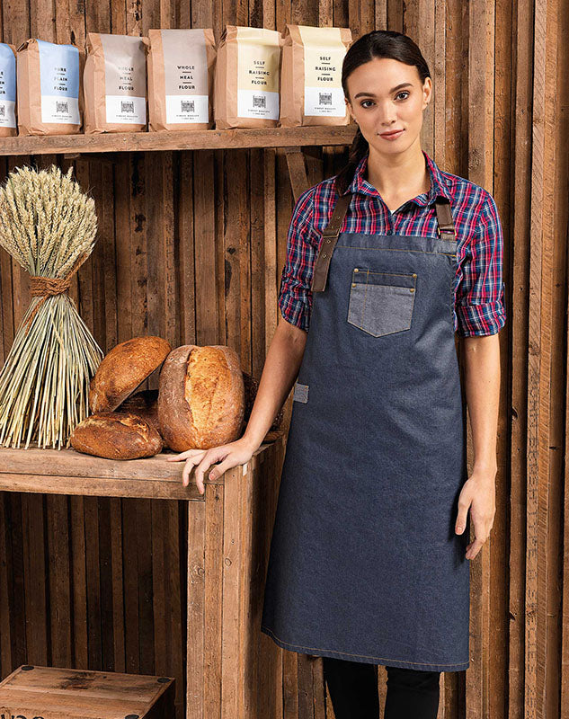 Model wearing the Division Waxed-Look Denim Bib Apron with Faux Leather